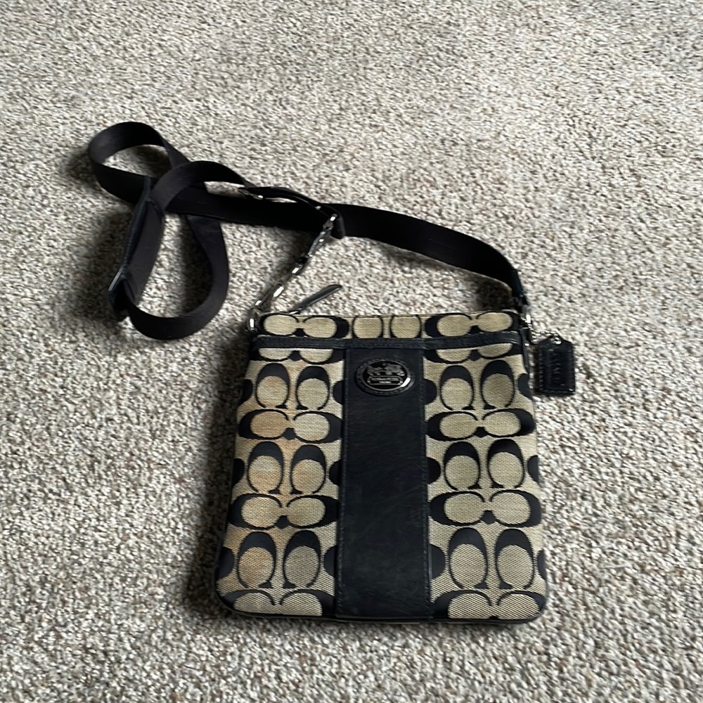 Coach crossbody bag tan with black “C” logo. 2 pockets in front and back